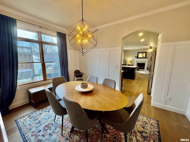 3096 Whitehaven Cir, Galesburg, IL 61401 - dining room with arched walkways, a decorative wall, and light wood-type flooring
