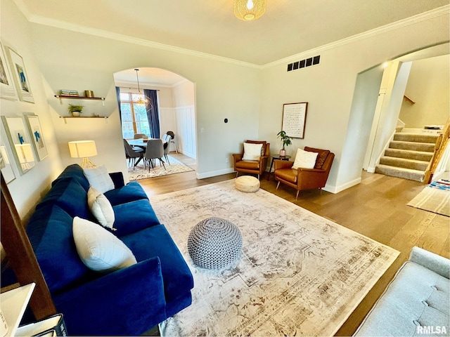 3096 Whitehaven Cir, Galesburg, IL 61401 - living room featuring arched walkways, visible vents, wood finished floors, stairway, and crown molding