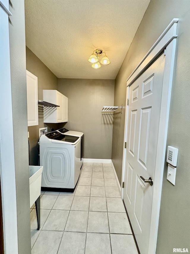 3096 Whitehaven Cir, Galesburg, IL 61401 - washroom with light tile patterned floors, washing machine and clothes dryer, baseboards, cabinet space, and a textured ceiling