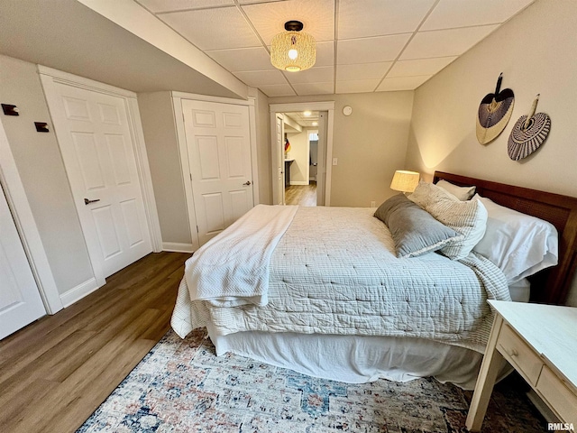 3096 Whitehaven Cir, Galesburg, IL 61401 - bedroom featuring baseboards, a paneled ceiling, and wood finished floors