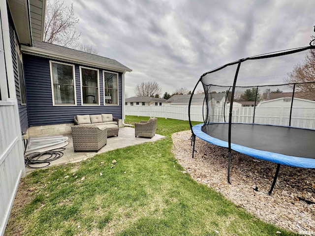 3096 Whitehaven Cir, Galesburg, IL 61401 - view of yard featuring outdoor lounge area, a fenced backyard, an outbuilding, a patio, and a trampoline