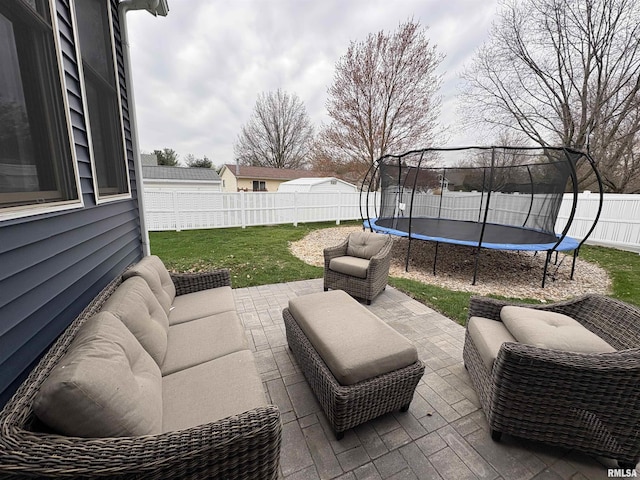 3096 Whitehaven Cir, Galesburg, IL 61401 - view of patio / terrace with an outdoor hangout area, a trampoline, and a fenced backyard