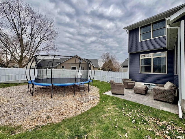 3096 Whitehaven Cir, Galesburg, IL 61401 - view of yard featuring a fenced backyard, a patio area, a trampoline, and an outdoor hangout area