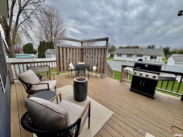 3096 Whitehaven Cir, Galesburg, IL 61401 - wooden deck with a pool, a fenced backyard, grilling area, outdoor dining area, and a residential view