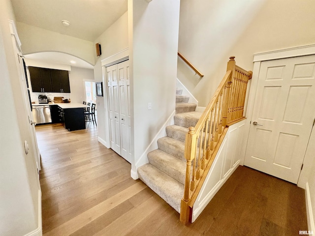 3096 Whitehaven Cir, Galesburg, IL 61401 - stairs with arched walkways, wood finished floors, and baseboards