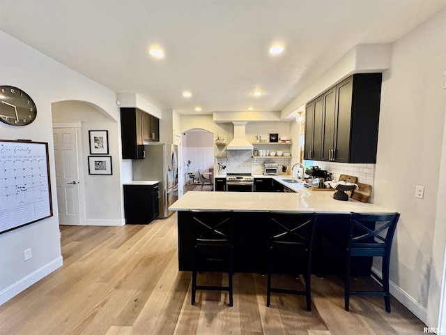 3096 Whitehaven Cir, Galesburg, IL 61401 - kitchen featuring open shelves, arched walkways, stainless steel appliances, premium range hood, and backsplash