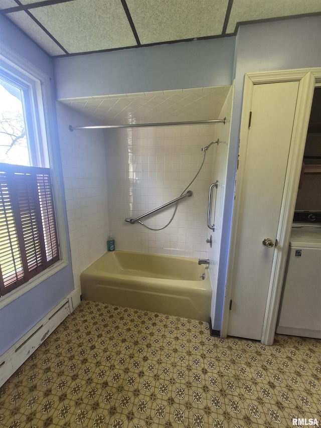 bathroom featuring a baseboard radiator, tile patterned floors, shower / bathing tub combination, and washer / clothes dryer
