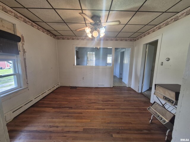 spare room featuring a baseboard heating unit, a paneled ceiling, hardwood / wood-style floors, and ceiling fan