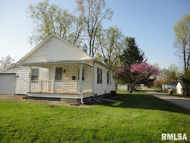 view of front of house with central AC, a front yard, and covered porch