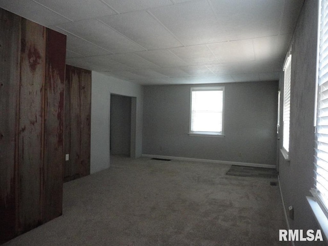 unfurnished room with carpet and visible vents