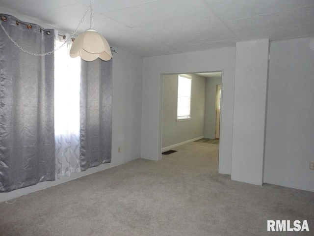 carpeted spare room with visible vents