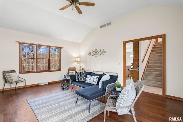 living room with lofted ceiling, a ceiling fan, stairs, and visible vents
