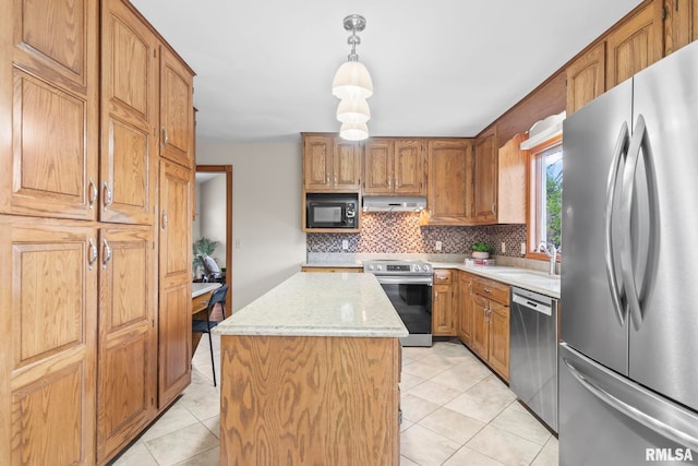 kitchen featuring under cabinet range hood, stainless steel appliances, a sink, a center island, and decorative backsplash