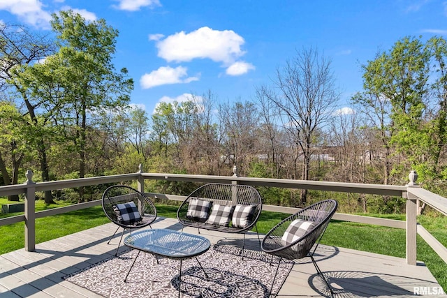 wooden terrace featuring a lawn