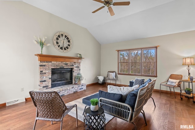 living area with vaulted ceiling, baseboards, visible vents, ceiling fan, and a fireplace