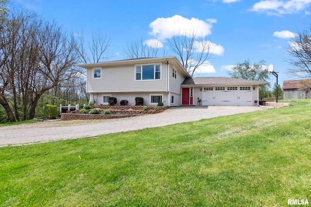 split level home with an attached garage, driveway, and a front yard