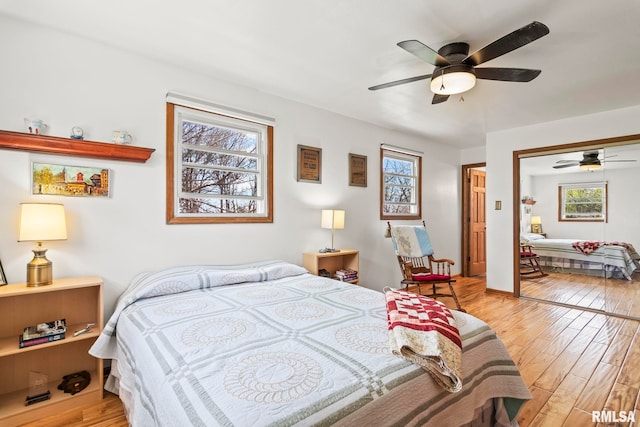 bedroom with wood finished floors, a closet, and ceiling fan