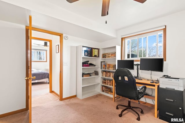 office space featuring baseboards, carpet floors, and ceiling fan