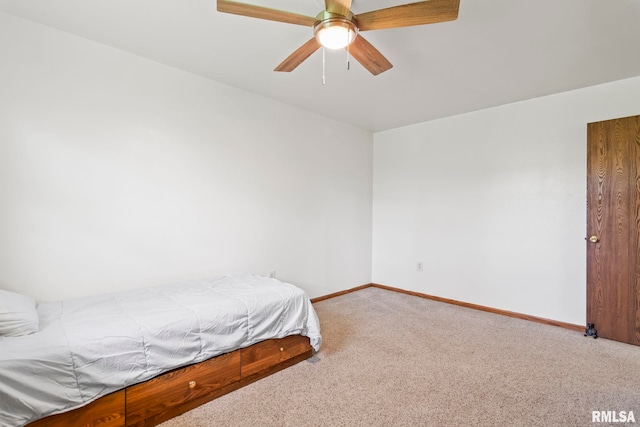 carpeted bedroom featuring a ceiling fan and baseboards