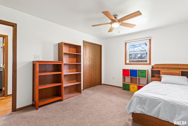 carpeted bedroom featuring ceiling fan, baseboards, and a closet