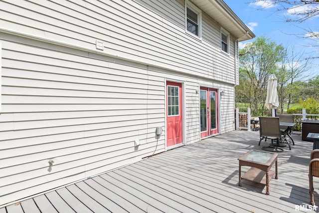 wooden deck featuring outdoor dining area