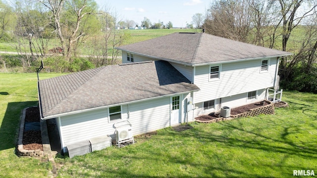 back of house with a lawn, central AC, and a shingled roof