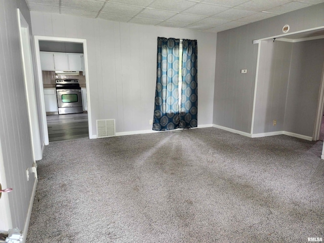 403 S Elm St, Lincoln, IL 62656 - empty room featuring carpet flooring and a drop ceiling
