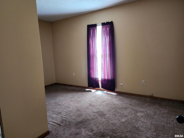 403 S Elm St, Lincoln, IL 62656 - empty room with carpet flooring and baseboards