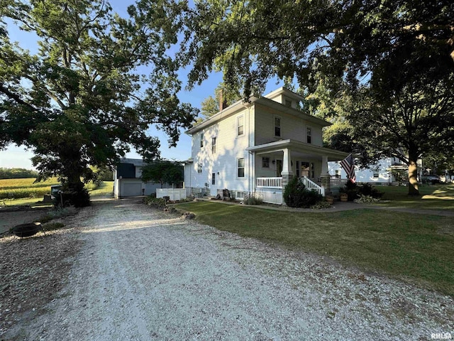 323 E Cortland St, Avon, IL 61415 - view of front facade featuring a porch, gravel driveway, a front lawn, and a garage