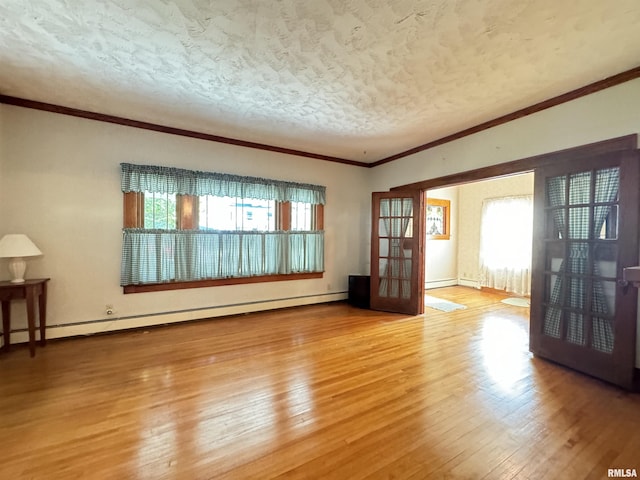 323 E Cortland St, Avon, IL 61415 - unfurnished living room with a baseboard heating unit, a textured ceiling, baseboards, crown molding, and hardwood / wood-style floors