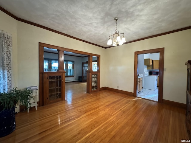 323 E Cortland St, Avon, IL 61415 - unfurnished dining area with baseboards, ornamental molding, a chandelier, and light wood finished floors