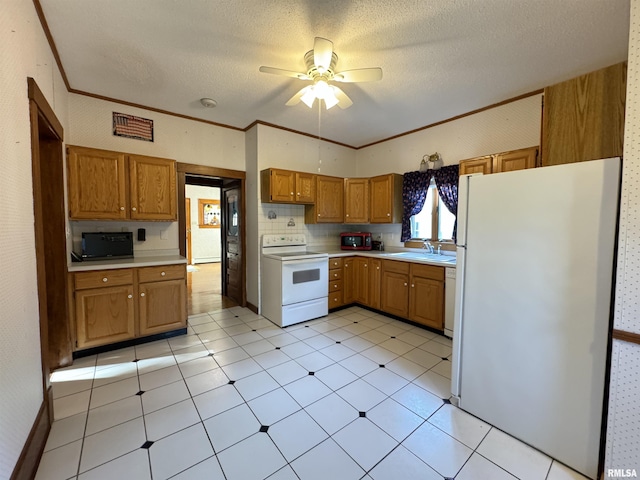 323 E Cortland St, Avon, IL 61415 - kitchen featuring a sink, white appliances, brown cabinets, ceiling fan, and light countertops