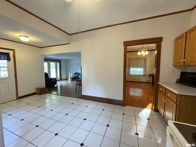 323 E Cortland St, Avon, IL 61415 - interior space featuring crown molding, brown cabinetry, light countertops, baseboards, and stove