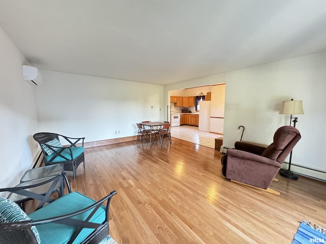 323 E Cortland St, Avon, IL 61415 - living area featuring a baseboard heating unit, an AC wall unit, baseboards, and light wood finished floors