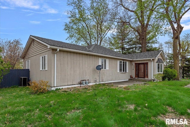 back of house with fence, a lawn, central AC, and a patio