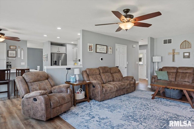 living area featuring recessed lighting, wood finished floors, visible vents, and a ceiling fan
