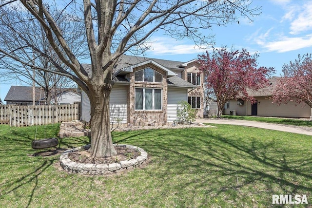 traditional-style house featuring brick siding, a front lawn, and fence