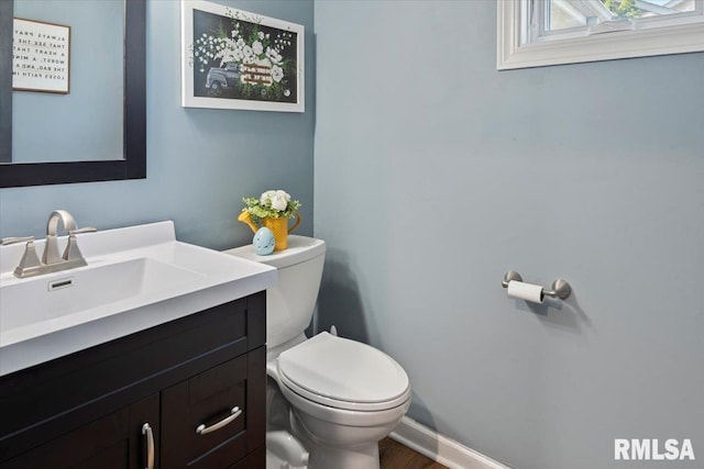 bathroom with toilet and vanity