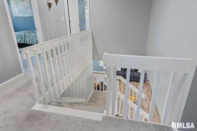 stairs featuring carpet flooring and baseboards