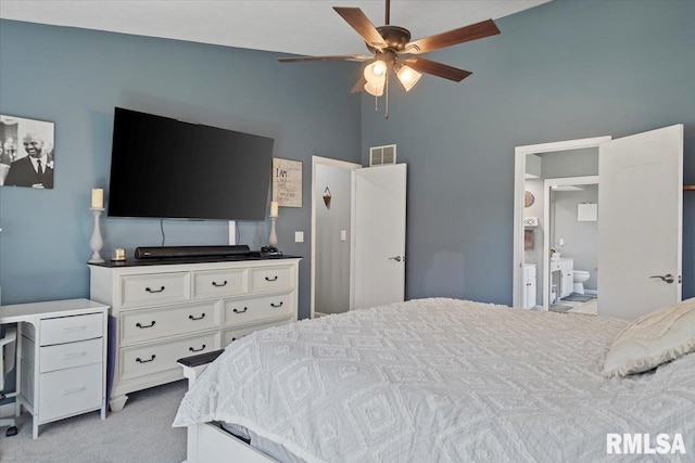 bedroom featuring high vaulted ceiling, ceiling fan, light carpet, ensuite bath, and visible vents