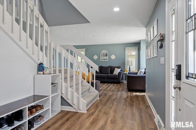 entryway featuring visible vents, baseboards, stairs, and a healthy amount of sunlight