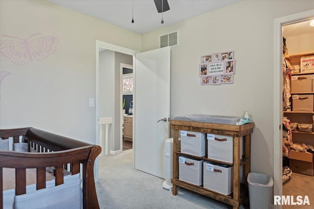 bedroom featuring a walk in closet, visible vents, and carpet flooring