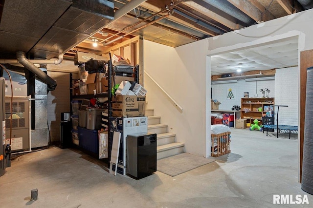 unfinished below grade area with heating unit and stairway