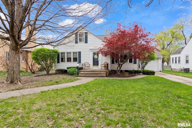 view of front facade featuring central AC, a front lawn, concrete driveway, and an attached garage