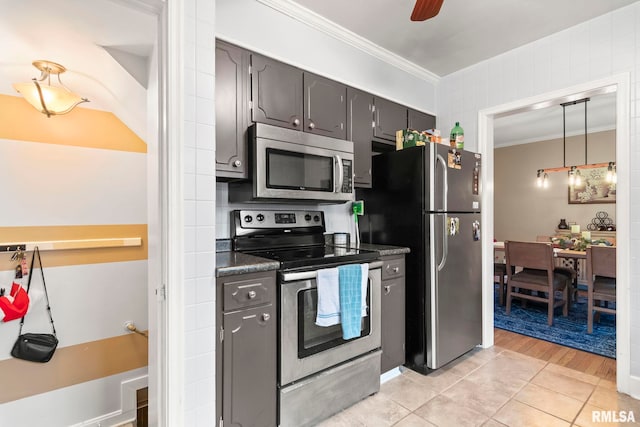 kitchen featuring dark countertops, a ceiling fan, gray cabinets, ornamental molding, and appliances with stainless steel finishes