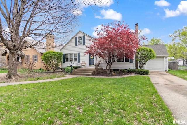view of property hidden behind natural elements featuring a garage, driveway, a chimney, and a front yard