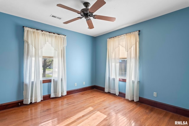 101 E Lester St, Williamsville, IL 62693 - empty room featuring baseboards, wood finished floors, visible vents, and ceiling fan