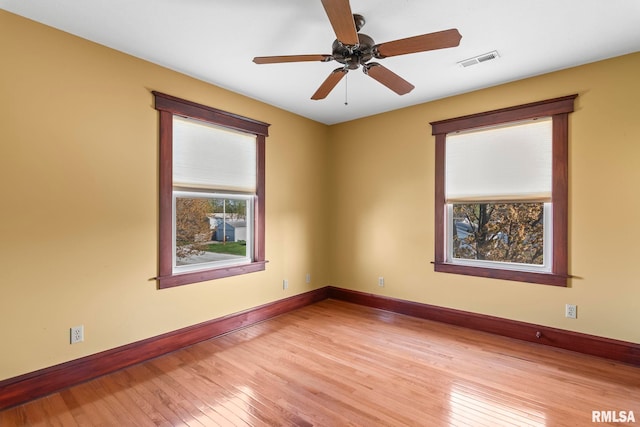 101 E Lester St, Williamsville, IL 62693 - spare room featuring ceiling fan, baseboards, visible vents, and light wood-type flooring