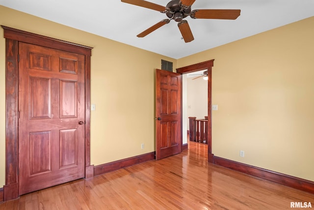 101 E Lester St, Williamsville, IL 62693 - unfurnished bedroom with light wood-type flooring, visible vents, a ceiling fan, and baseboards