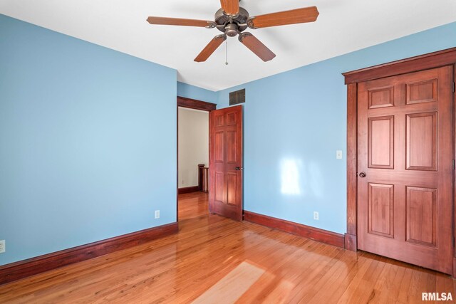 101 E Lester St, Williamsville, IL 62693 - unfurnished bedroom featuring visible vents, light wood finished floors, and baseboards